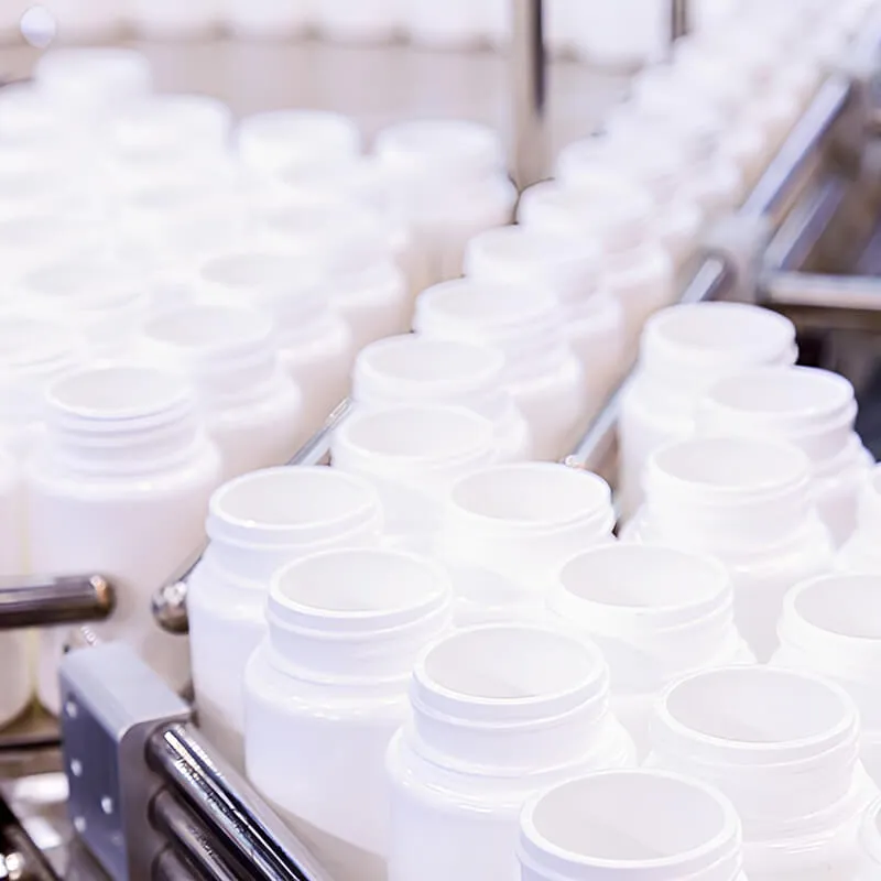 Conveyor belt with empty white bottles