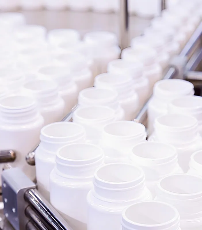 Conveyor belt with empty white bottles